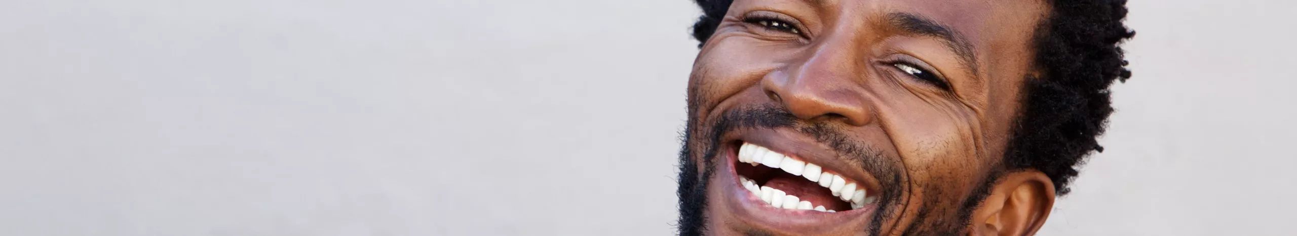 A man smiling because he heard the tips for getting out of debt