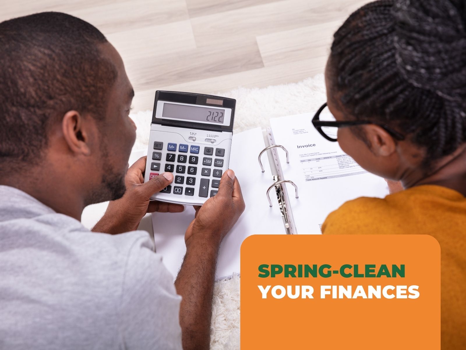A couple working out their expenses together to spring-clean their finances.
